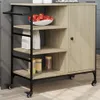 A kitchen cart with shelves and a cabinet, stocked with apples, bags, and jars of food. Náhled obrázku produktu