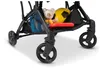 Close-up of the lower part of a stroller, showing the storage basket with a teddy bear, a yellow ball, and a red toy. Voir les images du produit