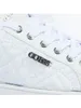 Close-up view of a white Guess sneaker. Podgląd zdjęcia produktu