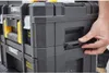 A person's hand is shown operating a latch on a stack of STANLEY FATMAX TSTAK toolboxes. Voir les images du produit