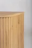 A close-up view of the fluted wooden side and top of a cabinet. Voir les images du produit