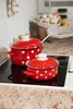 Two red and white polka dot pots on a stovetop. Anteprima dell’immagine prodotto