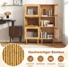 A modern living room scene featuring a bamboo cabinet with glass doors, displaying books and a record player. The image also includes marketing text and icons. Produktbild-Vorschau