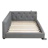 A grey upholstered daybed with a slatted mattress base is shown from a side angle against a white background. Produktbild-Vorschau