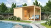 A wooden sauna house with a covered patio area next to a swimming pool, surrounded by greenery and mountains in the background. Produktbild-Vorschau