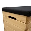 A close-up view of the top corner of a wooden storage box with a black cushion on top. Anteprima dell’immagine prodotto