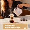 A person is pouring hot water from an electric kettle into a pour-over coffee maker. Podgląd zdjęcia produktu