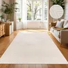 A living room with a large rug, sofa, and windows. Anteprima dell’immagine prodotto
