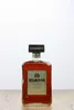 A bottle of Disaronno Originale Amaretto liqueur is centered on a wooden surface against a white background. Produktbild-Vorschau