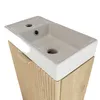 A close-up view of a white ceramic sink on top of a wooden cabinet with a ribbed front. Náhled obrázku produktu