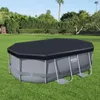 An above-ground swimming pool with a black cover, set up on a green lawn in a backyard with trees and a palm tree in the background. Produktbild-Vorschau