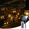 A string of star and moon-shaped LED lights hanging on a balcony railing at night, powered by a solar panel. Náhľad obrázku produktu