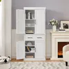A white storage cabinet with multiple shelves and drawers, shown in a room with a fireplace and a rug. Produktbild-Vorschau