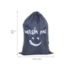 A gray laundry bag with 'wash me' and a smiley face printed on it, with dimensions indicated. Produktbild-Vorschau