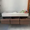 A double sink vanity with drawers, with flowers on top. Anteprima dell’immagine prodotto