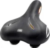 A black bicycle saddle with silver and orange accents, presented on a white background. Podgląd zdjęcia produktu