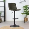 A bar stool in a room with plants and decor. Anteprima dell’immagine prodotto