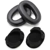 Two pairs of black headphone ear pads are shown against a white background. The top pair are larger, oval-shaped ear pads, and the bottom pair are smaller, circular ear pads with foam inserts. Náhled obrázku produktu