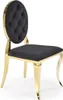 A studio shot of a black and gold chair. Podgląd zdjęcia produktu