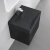 A modern black bathroom vanity with a sink and faucet, mounted on a white wall with gray tiled flooring. Produktbild-Vorschau