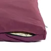 A close-up of a plum-colored cushion with a partially unzipped opening revealing a beige interior. Produktbild-Vorschau