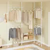 A corner of a room with a white modular closet system holding various clothing items and accessories. Produktbild-Vorschau