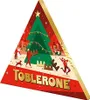 A triangular Toblerone advent calendar with a Christmas tree and festive scene. Produktbild-Vorschau