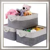 Three fabric storage baskets filled with toys and snacks. Anteprima dell’immagine prodotto