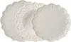 Three white plates are stacked and angled, with embossed designs around the rim. Produktbild-Vorschau