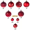 A collection of red Christmas ornaments of various sizes and textures, arranged in a pyramid formation with quantity labels. Podgląd zdjęcia produktu