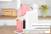 Die Unold Slush-Eismaschine Susi spendet rosa Wassermelonen-Slush in ein Glas mit einer Wassermelone Produktbild-Vorschau