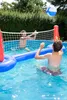 Two young people playing volleyball in a swimming pool. Podgląd zdjęcia produktu