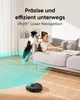 A woman is relaxing on a sofa, using a laptop, while a dog looks on. A robotic vacuum cleaner is cleaning the floor, with a light blue overlay indicating its navigation path. The text "Präzise und effizient unterwegs iPath™ Laser Navigation" is displayed a Anteprima dell’immagine prodotto