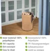 A laundry basket filled with blankets and clothes is placed on a wooden floor in front of a white cabinet with glass doors. Náhled obrázku produktu