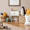 A child's bedroom with a nightstand, toys, and decor. Podgląd zdjęcia produktu