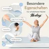 A woman is sitting on a mattress with her arms outstretched, appearing relaxed. The image also features close-up shots of a quilted fabric and a rolled-up textile, with text highlighting product features. Produktbild-Vorschau
