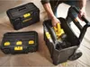 A person is placing a yellow power tool into a rolling tool chest. Two other toolboxes are visible in the background. Voir les images du produit