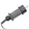 A close-up shot of a black and green electrical plug with silver prongs, isolated on a white background. Anteprima dell’immagine prodotto