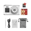 A white digital camera and its accessories are laid out on a white background. Produktbild-Vorschau
