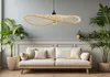 A living room scene with a sofa, plants, and a hanging lamp. Produktbild-Vorschau