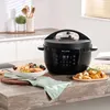 A black Instant Pot multicooker is shown on a wooden countertop, with dishes of food next to it. Anteprima dell’immagine prodotto