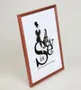 A framed print with a fashion illustration and text is displayed against a white background. Produktbild-Vorschau