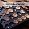 Close-up of a waffle iron with cooked waffle halves in some of the molds. Voir les images du produit