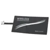 A black wireless charging receiver with a silver connector. Produktbild-Vorschau
