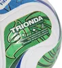 A close-up of a soccer ball with a green and gold label. Produktbild-Vorschau
