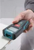 A hand holding a Makita laser distance measurer over a wooden surface. Produktbild-Vorschau