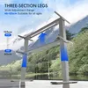 A gray adjustable desk frame is shown in a natural outdoor setting with mountains and a lake in the background. Produktbild-Vorschau