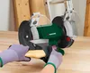 A person is using a bench grinder to sharpen a piece of wood. Produktbild-Vorschau