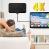 A person relaxing on a couch watching TV, with a digital antenna mounted on the wall. Podgląd zdjęcia produktu