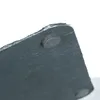 Close-up view of the underside of a slate serving platter, showing one of its rubber feet. Náhled obrázku produktu